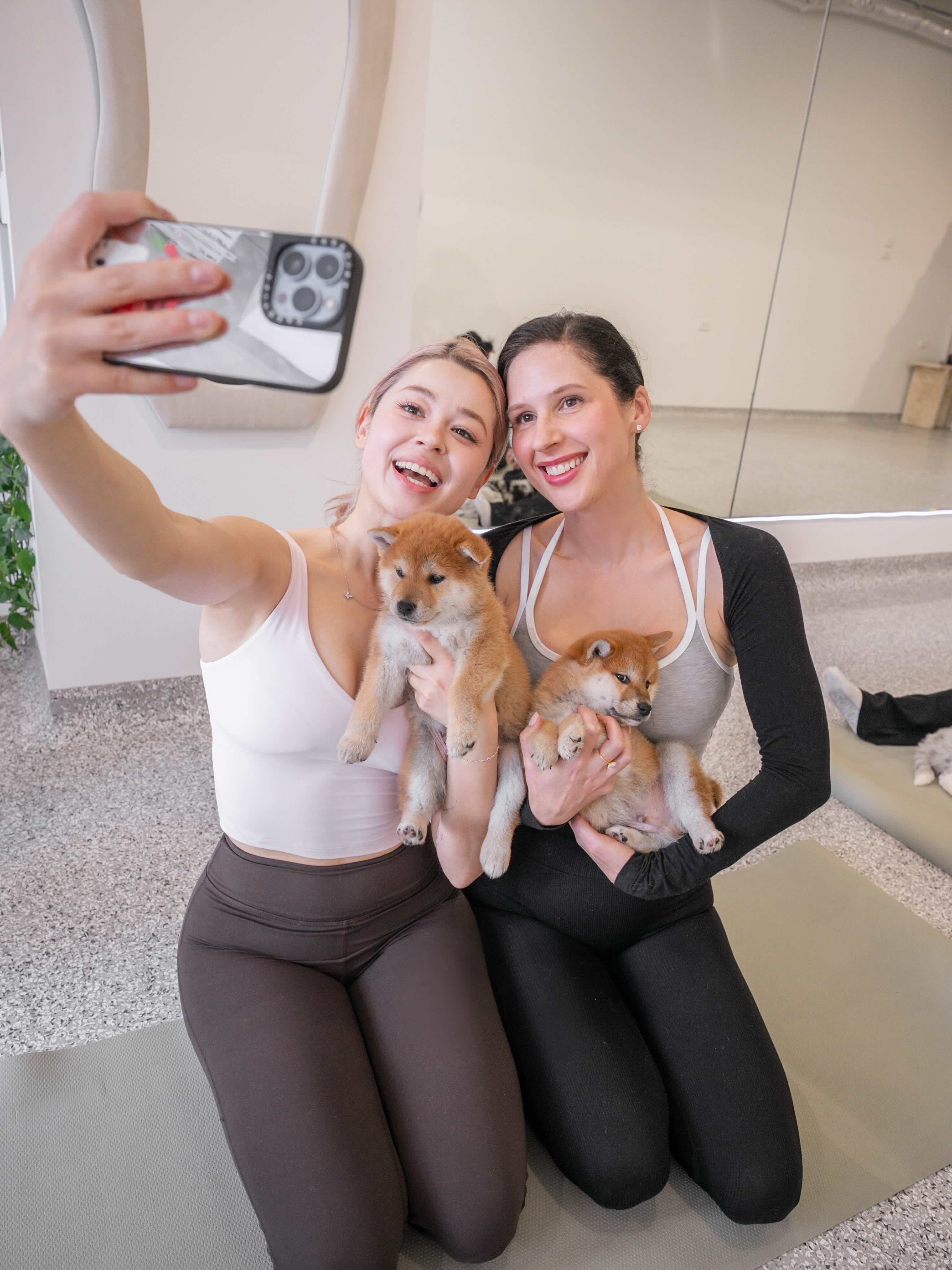 Family with children playing with golden retriever puppies